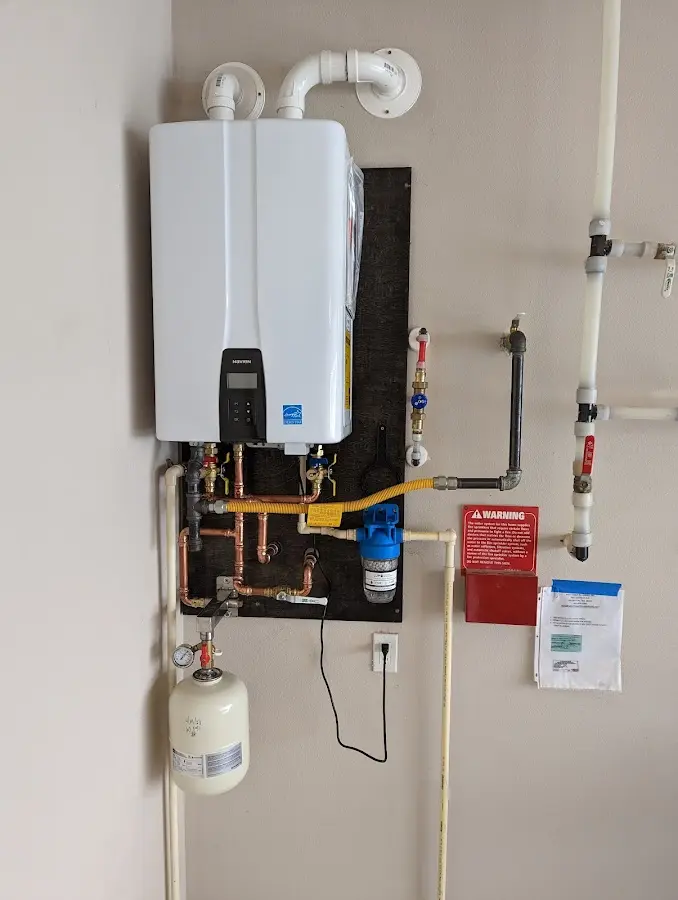 Professional plumber installing copper piping in a Snowflake home